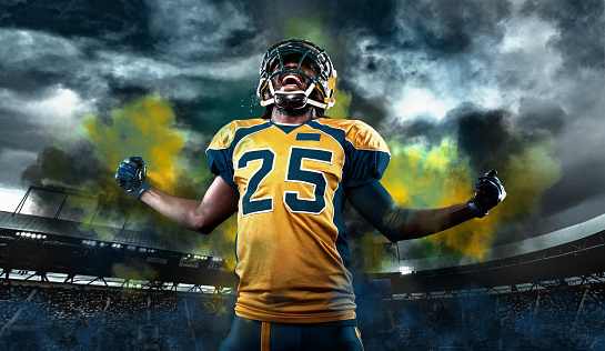 American Football player on stadium with smoke and lights.