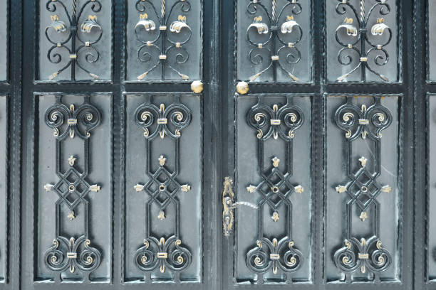 istock Black wrought iron doors with golden ornaments 1358118331