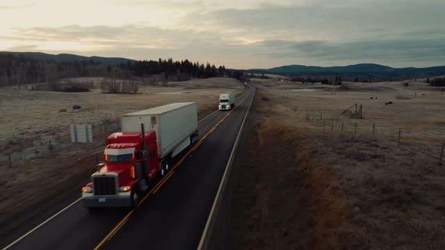 Drone POV of a transport truck driving on a country road