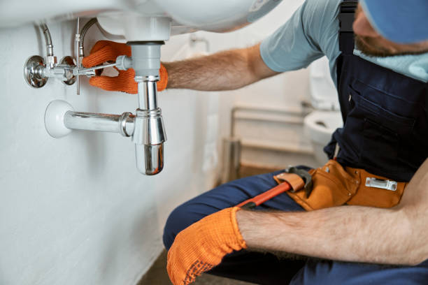 istock Male plumber hands repairing pipe under sink 1358127617