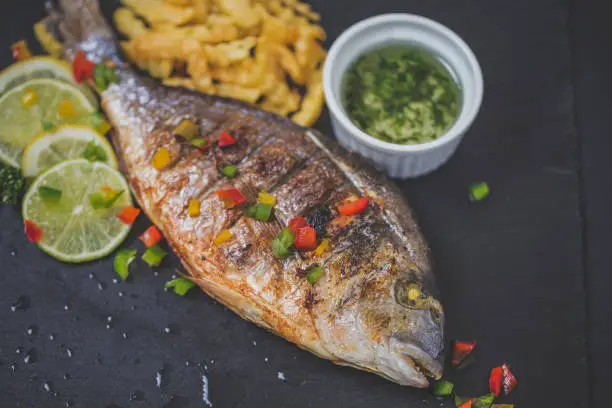 Photo of Grilled trout with french fries and lemon