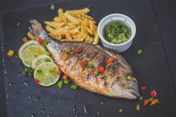 Photo of Grilled trout with french fries and lemon