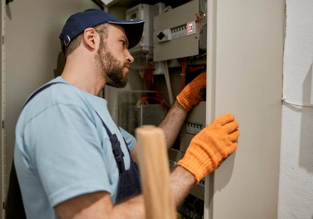 istock Male electrician checking electrical panel in house 1358129808