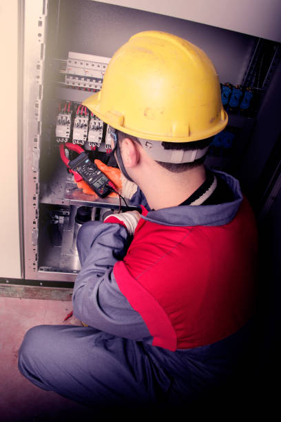 istock Close up electrician working on electric panel 1358132292