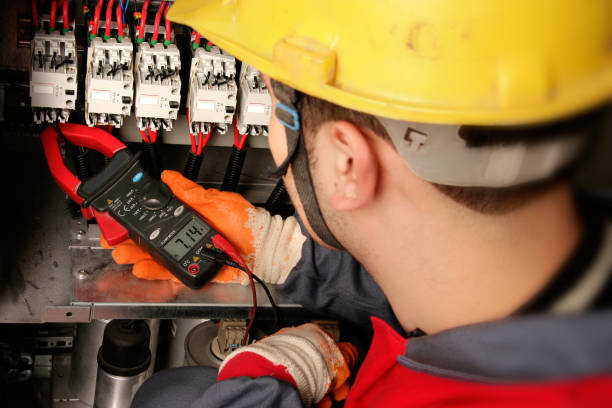 istock Close up electrician working on electric panel 1358132327