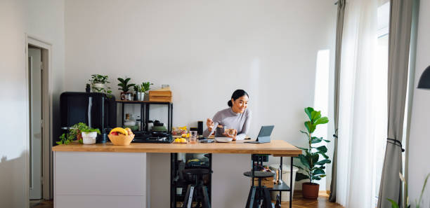 istock Smiling Woman Making Healthy Breakfast in Kitchen 1358132395