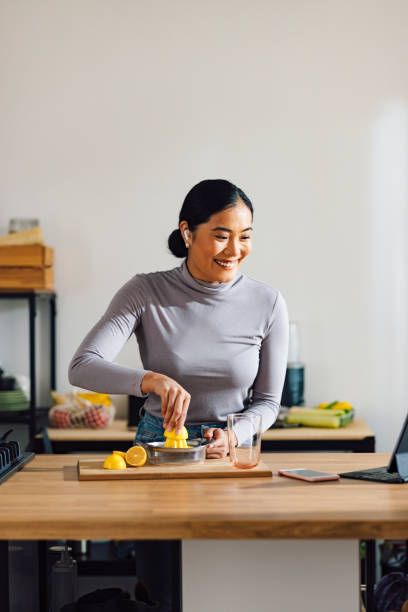 istock Happy Woman Talking on Video Call while Making Healthy Breakfast in the Kitchen 1358132408