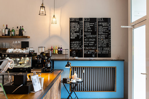 Interior of a cafeteria with the menu on the wall. Shot of an empty coffee shop.