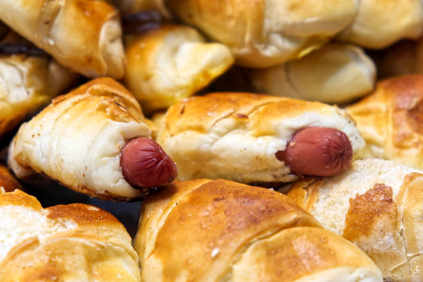 a group of savory croissants stuffed with wurstel