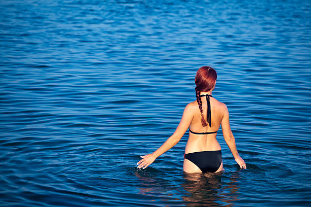 istock Young woman staying in sea 135813288