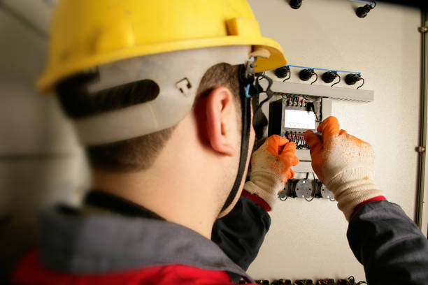 istock Close up electrician working on electric panel 1358133259