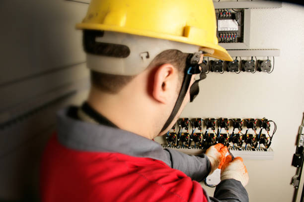 istock Close up electrician working on electric panel 1358133260