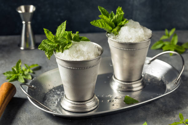 Boozy Refreshing Bourbon MInt Julep Boozy Refreshing Bourbon MInt Julep with Ice and Sugar mint julep photos stock pictures, royalty-free photos & images