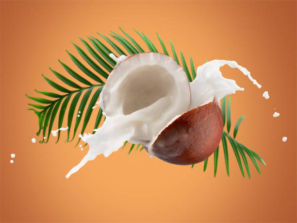 istock coconuts with milk splash and green leaves on a yellow background 1358137880