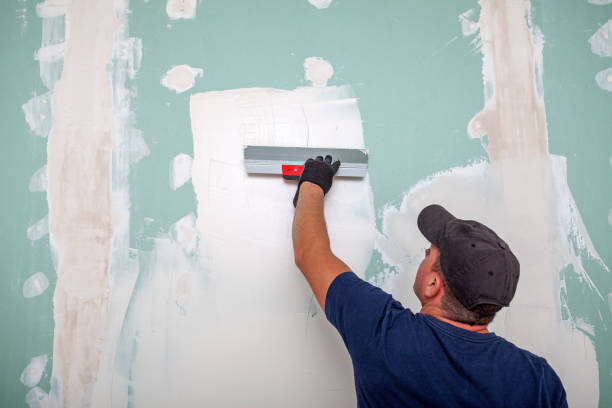 istock Hand of builder worker plastering at wall 1358138883