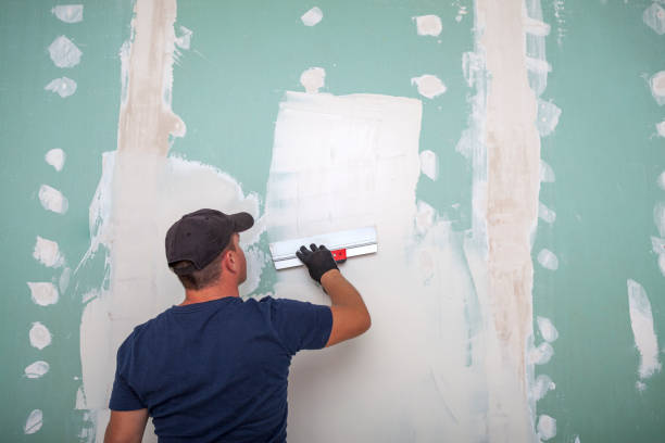 istock Hand of builder worker plastering at wall 1358138888