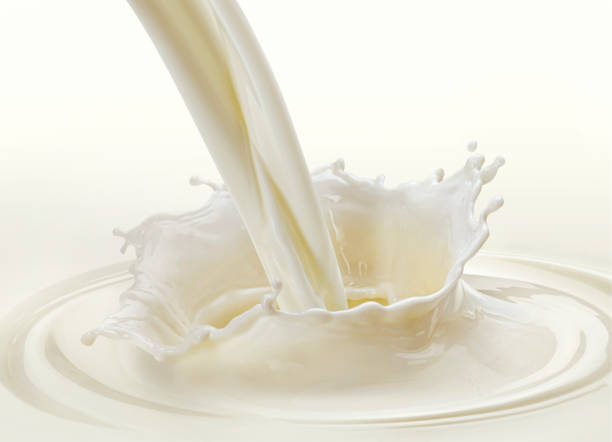 istock Pouring milk splash on white background 1358139927