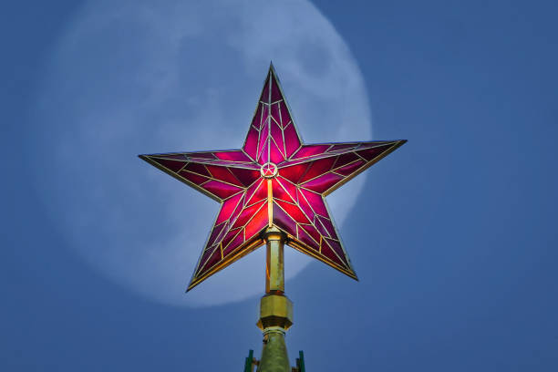 istock Red Kremlin star at night, full moon on background 1358140192