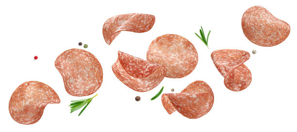 Sliced salami sausage isolated on white background Falling sliced salami sausage isolated on white background with clipping path salami stock pictures, royalty-free photos & images