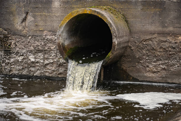 istock Dirty water flows from the pipe into the river, environmental pollution. Sewerage, treatment facilities 1358141244