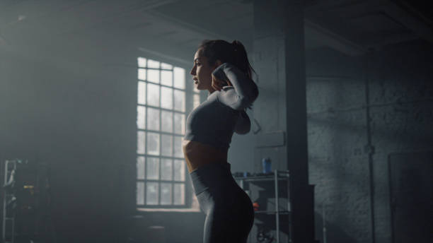 istock Woman warming shoulders before training. Young sportswoman moving hands 1358141391