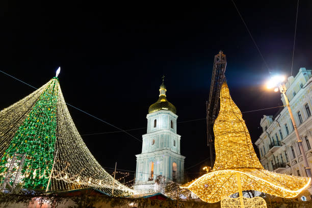 istock Beautiful scenic decorated Christmas Tree with decorations and illuminated by light garlands against Sophia Cathedral on background Sofievska square market. Happy 2022 New Year and xmas Celebration 1358142225