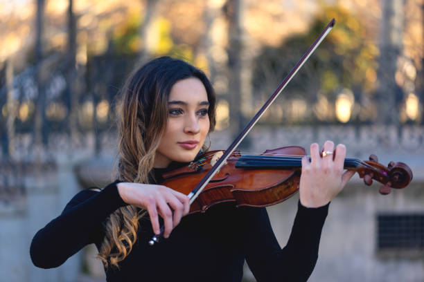 istock playing the violin in the street 1358142313