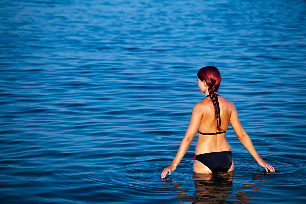 istock Young woman relaxing in sea 135814400
