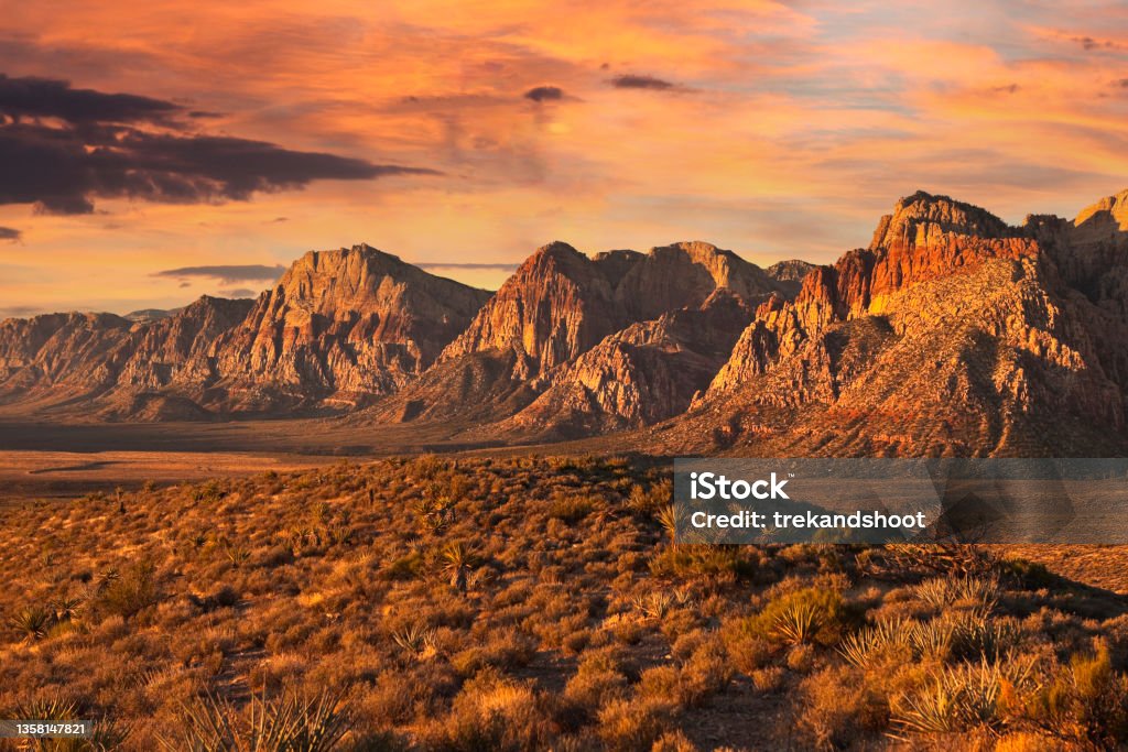 Nevada Desert Dawn with Dramatic Sky Dramatic dawn light on the cliffs of Red Rock Canyon National Conservation Area near Las Vegas, Nevada. Las Vegas Stock Photo