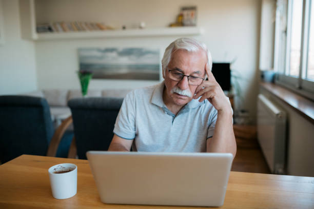 istock Elderly Caucasian man using a laptop at home 1358149562