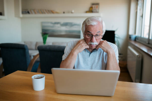 istock Elderly Caucasian man using a laptop at home 1358149582