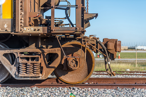 Close up view of shiny metal and welds after the repair to a railway track. No people.