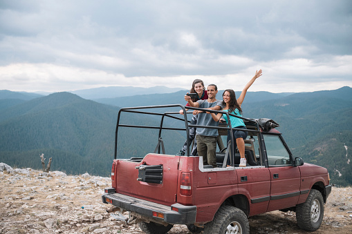 Friends on a tourism trip in a off road jeep in the mountains