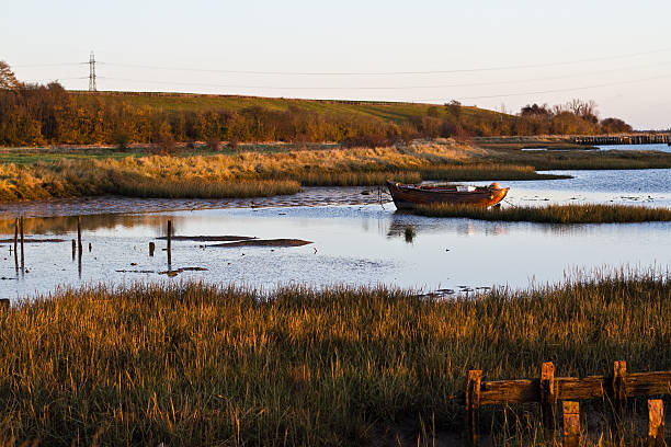 A small wooden fishing boat takes the morning off in Kent UK.