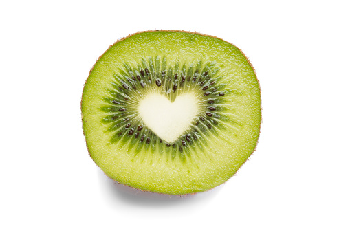 Kiwi cut in half. The center of the kiwi has a heart shape as a concept of healthy food