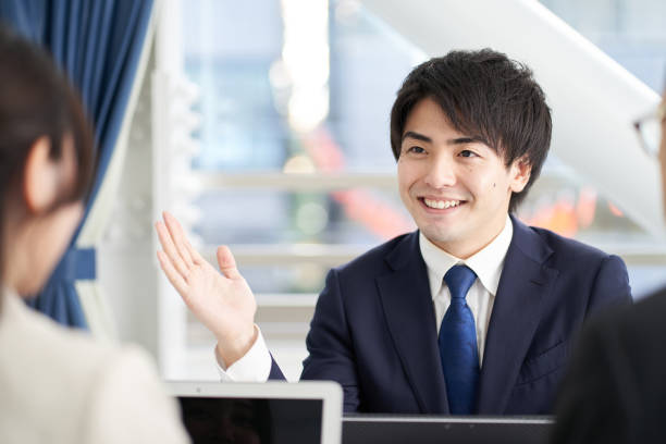 Asian businessman explaining at a meeting Asian businessman explaining at a meeting japanese ethnicity stock pictures, royalty-free photos & images