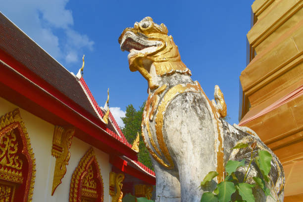 istock Wat Phra Ruang, Lion Statue between Temple and Chedi, Mueang Phrae District, Thailand 1358159001