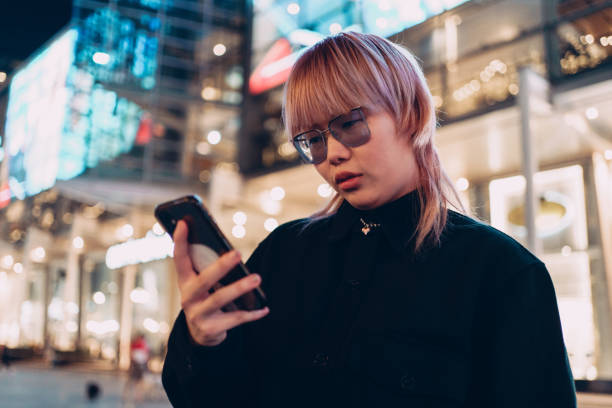 istock Woman is using phone in the city 1358159861