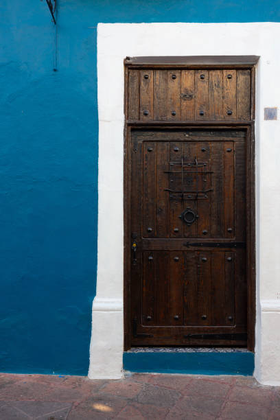 istock Dark brown wooden door 1358163100
