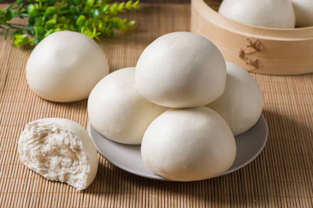istock Chinese food steamed buns in plate on table. 1358165619