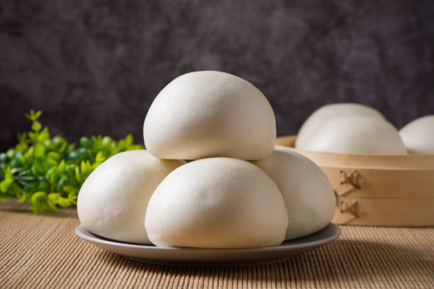istock Chinese food steamed buns in plate on table. 1358165643