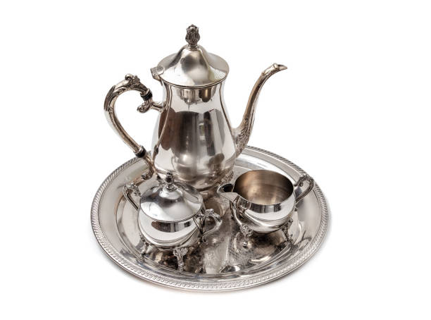 istock Ornate 4-piece tea set on table, isolated on white. 1358168435