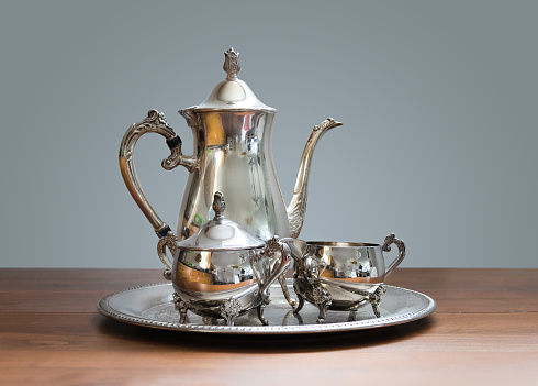 Ornate 4-piece tea set on table.