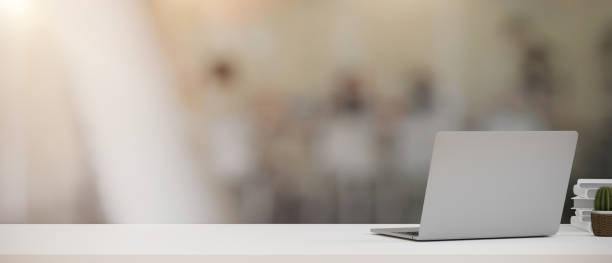 istock Laptop and copy space on office desk over blurred office background. 1358169525
