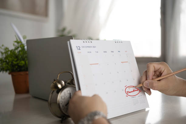 istock Hand with pen mark calendar. deadline 1358169715