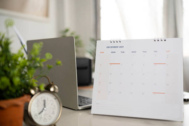 istock Simple desk calendar for December 2021 on workplace background. 1358170811