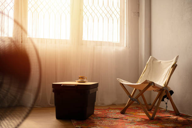 istock Sun light shines through window on a chair 1358170818