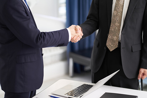 Asian business person shaking hands