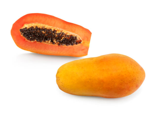 whole and half of ripe papaya fruit with seeds isolated on white background whole and half of ripe papaya fruit with seeds isolated on white background relish green food isolated stock pictures, royalty-free photos & images