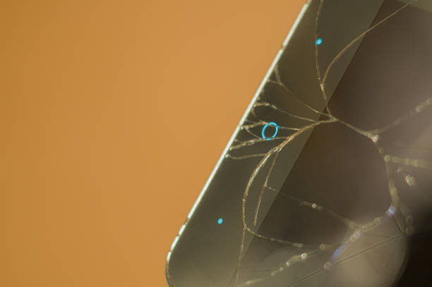 istock Smartphone with broken display glass. Cracked screen glass. Broken phone. Selective focus 1358179132